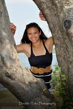 Nichole leaning on tree